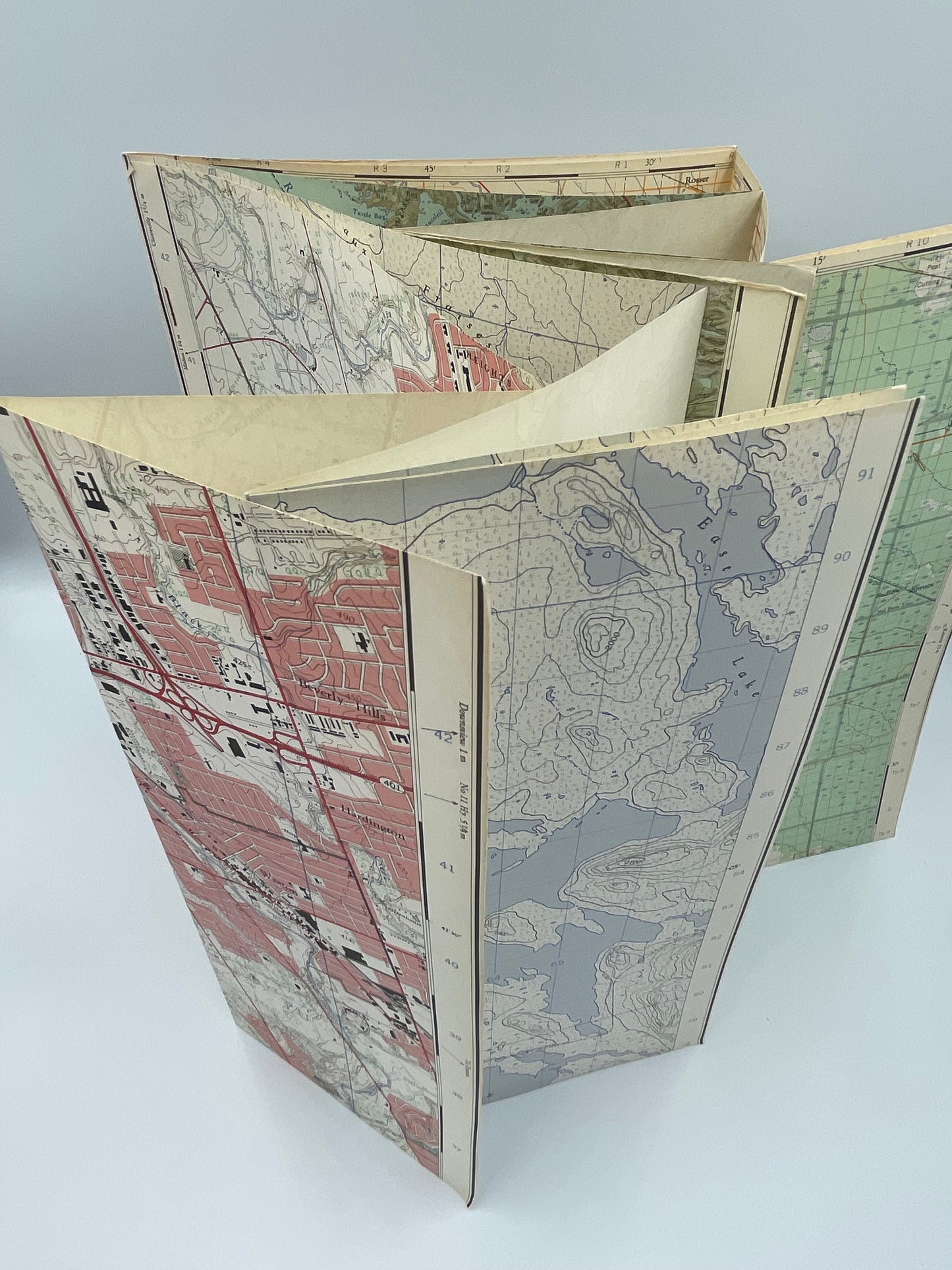 Opened upright topographical maps from “Every Square Inch by L.M. Sebert.