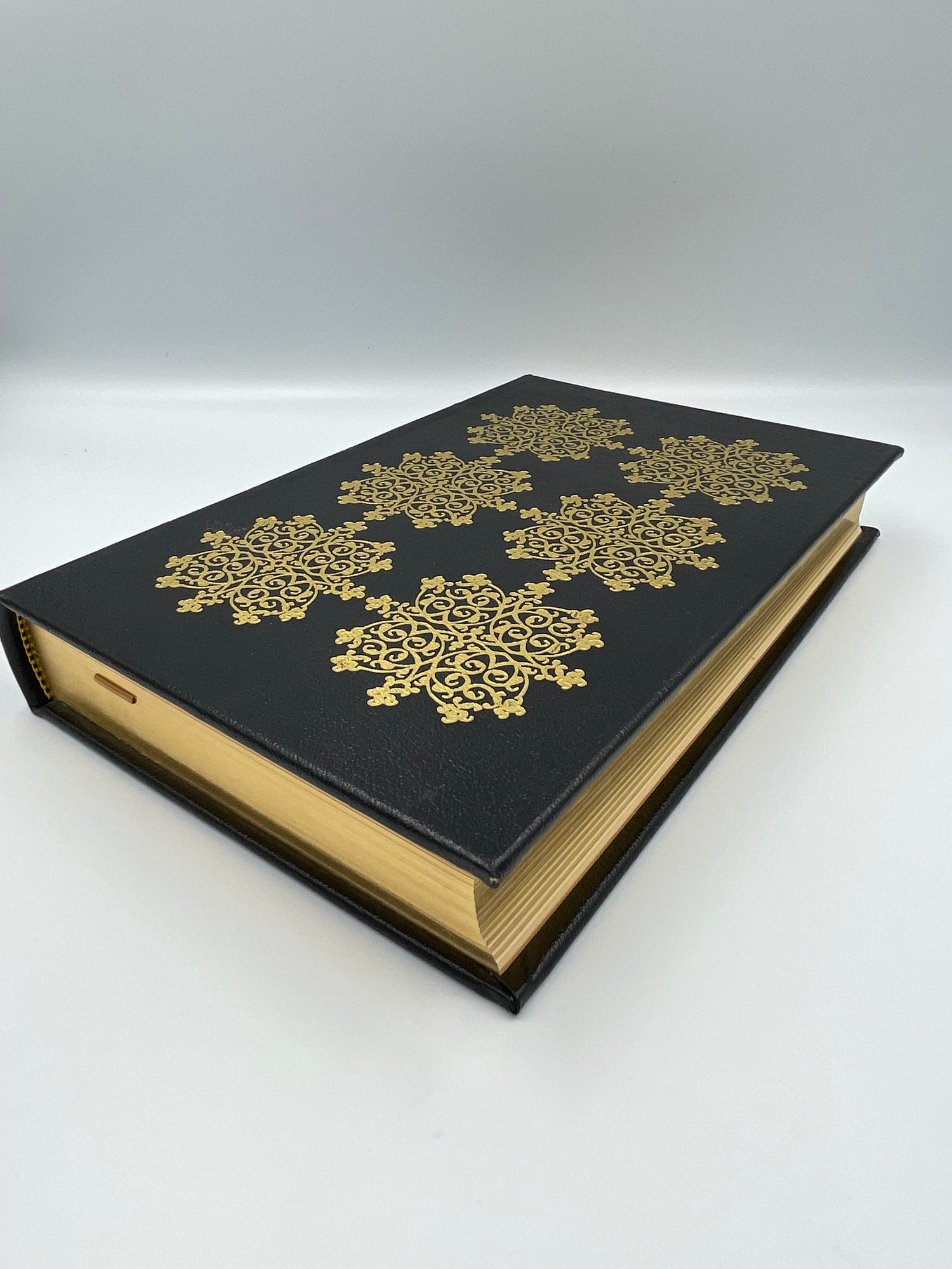 Beautiful leather bound book with gold gilt edges and elegant motifs on the cover. 