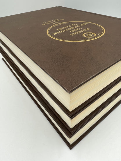 3 book stacked view of Webster’s Third New International Dictionary.