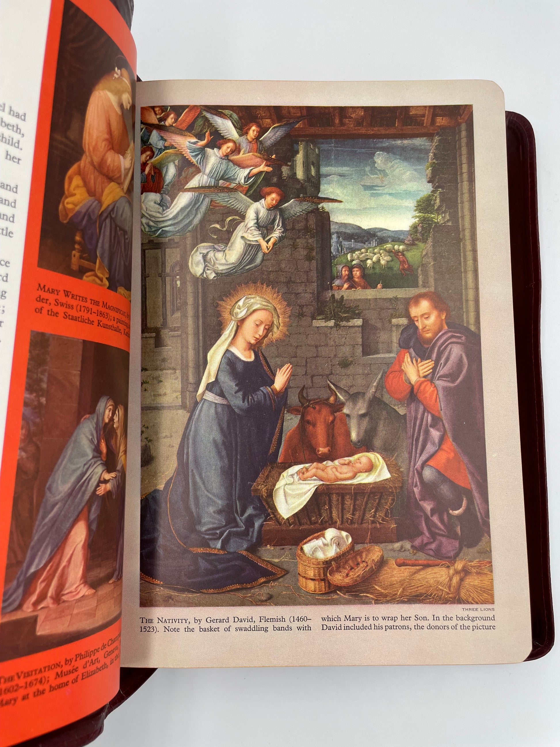 Page with image of painting depicting th baby Jesus in a manger with the Virgin Mary, Joseph and angels. from 'The Marian Bible'.