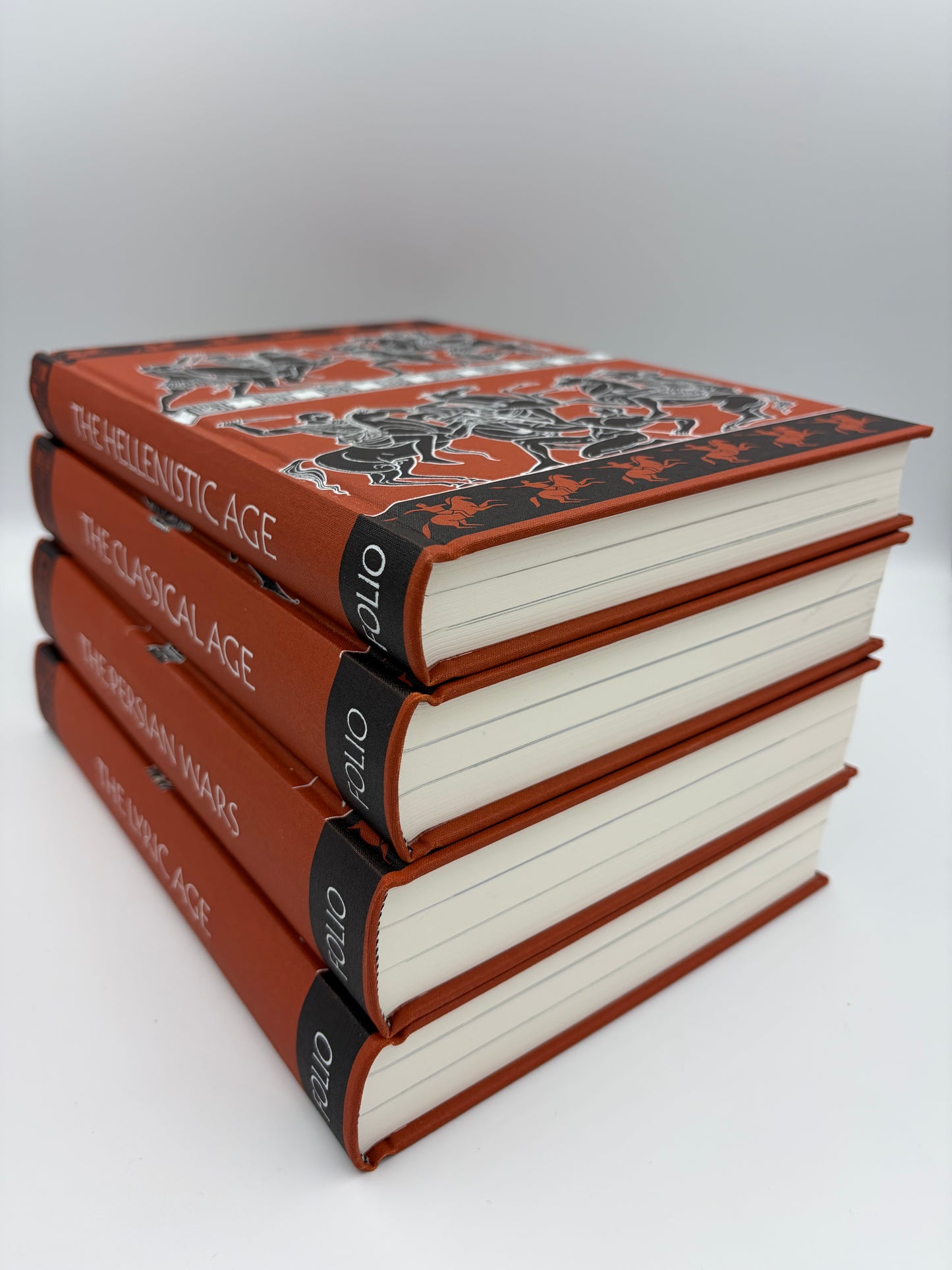 A stack of four hardcover books from the set 'The Folio History of Ancient Greece' 