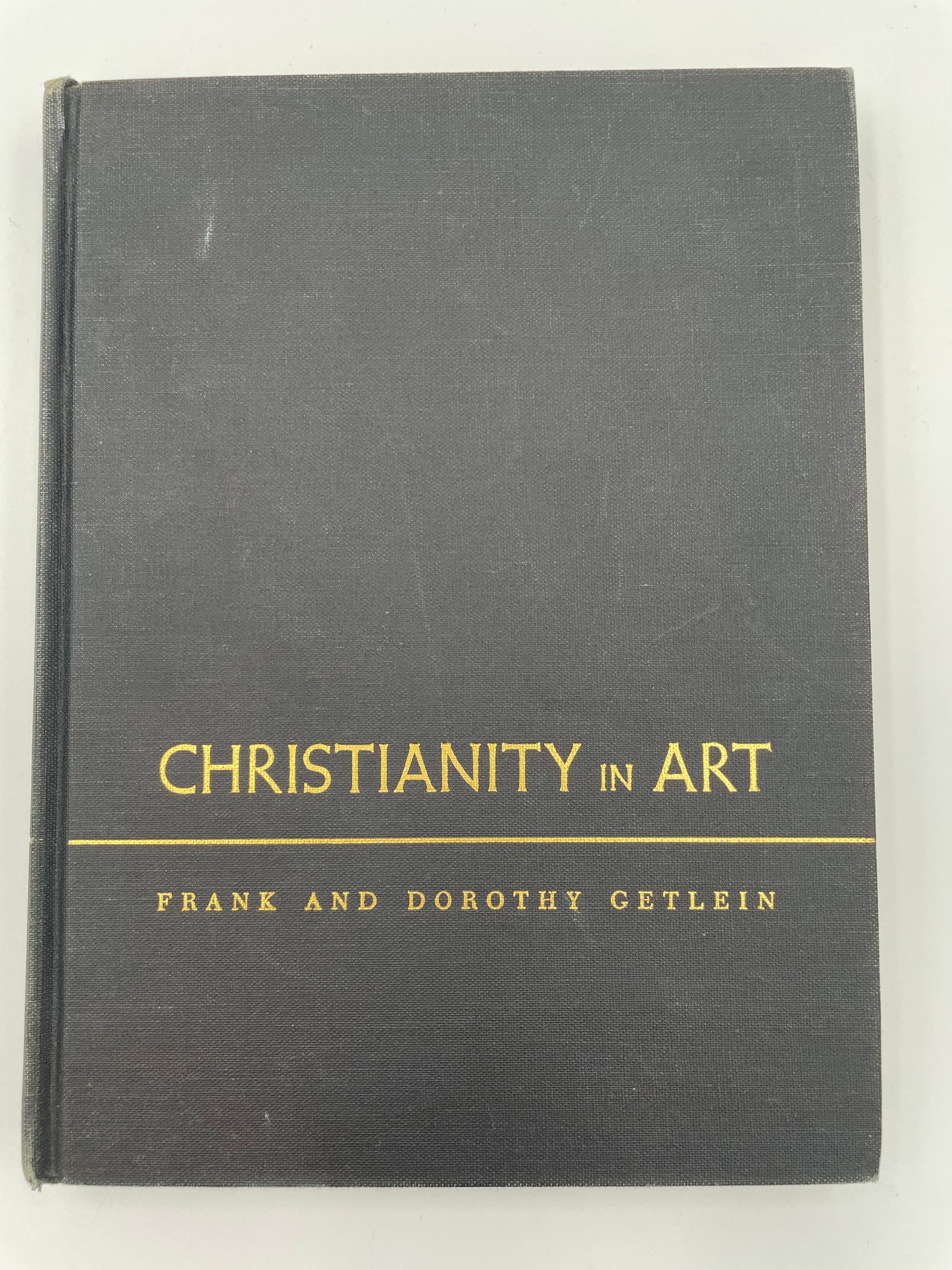 Book titled 'Christianity in Art' by Frank and Dorothy Getlein on a white background