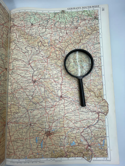 Map of Germany with a magnifying glass on top from the Times Atlas of the world 