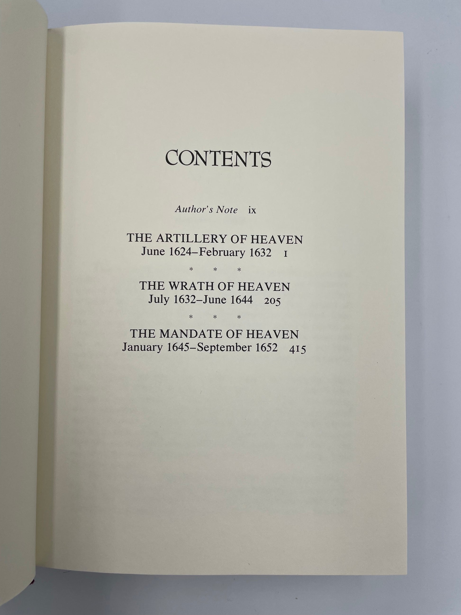 Book open to a contents page from "Manchu" by Rober Elegant on a light gray background