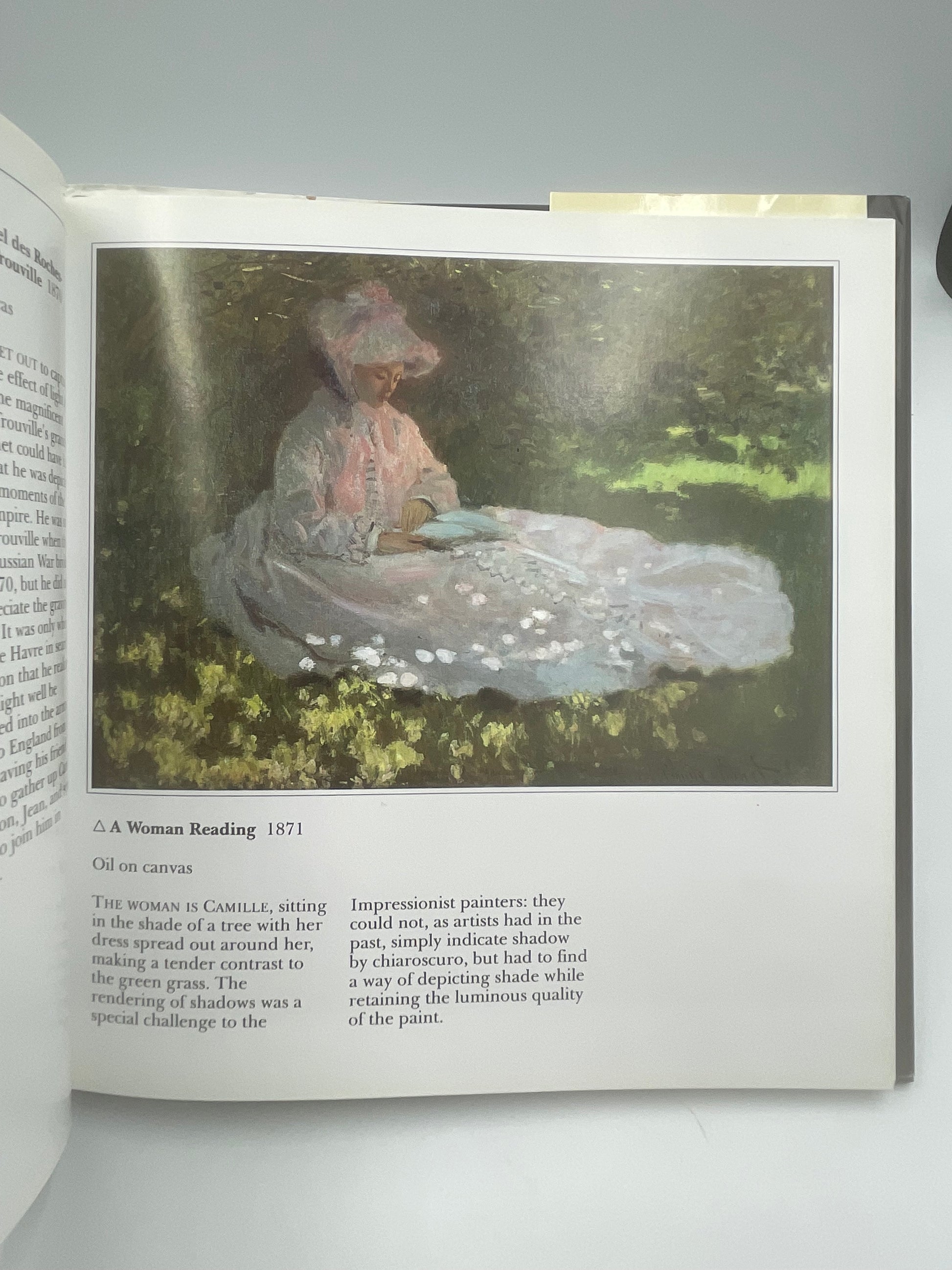 Text and painting of a woman reading from The Life and Works of Monet by Edmund Swinglehurst