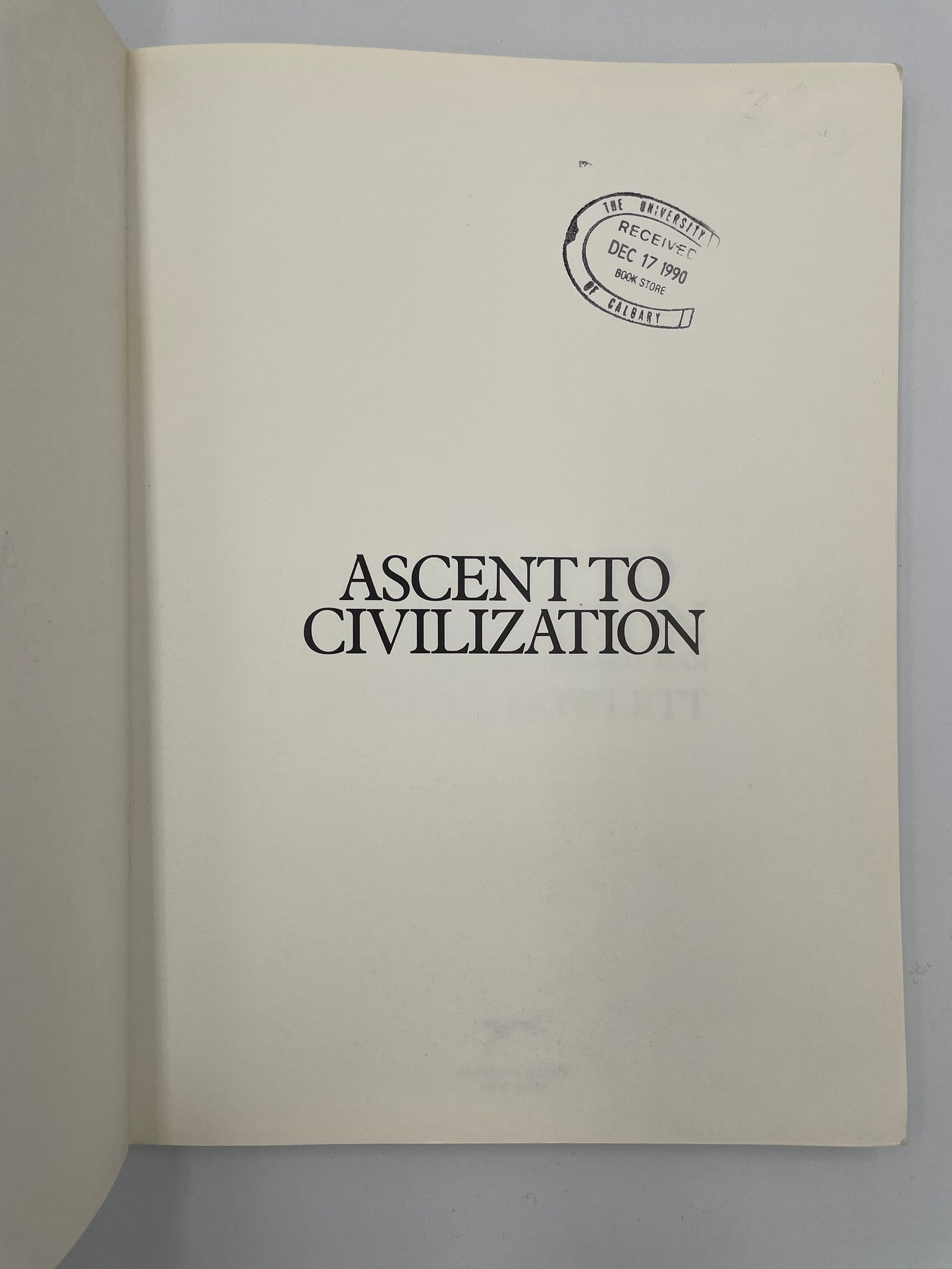 Title page of 'Ascent to Civilization' with a visible stamp on the cover against a gray background