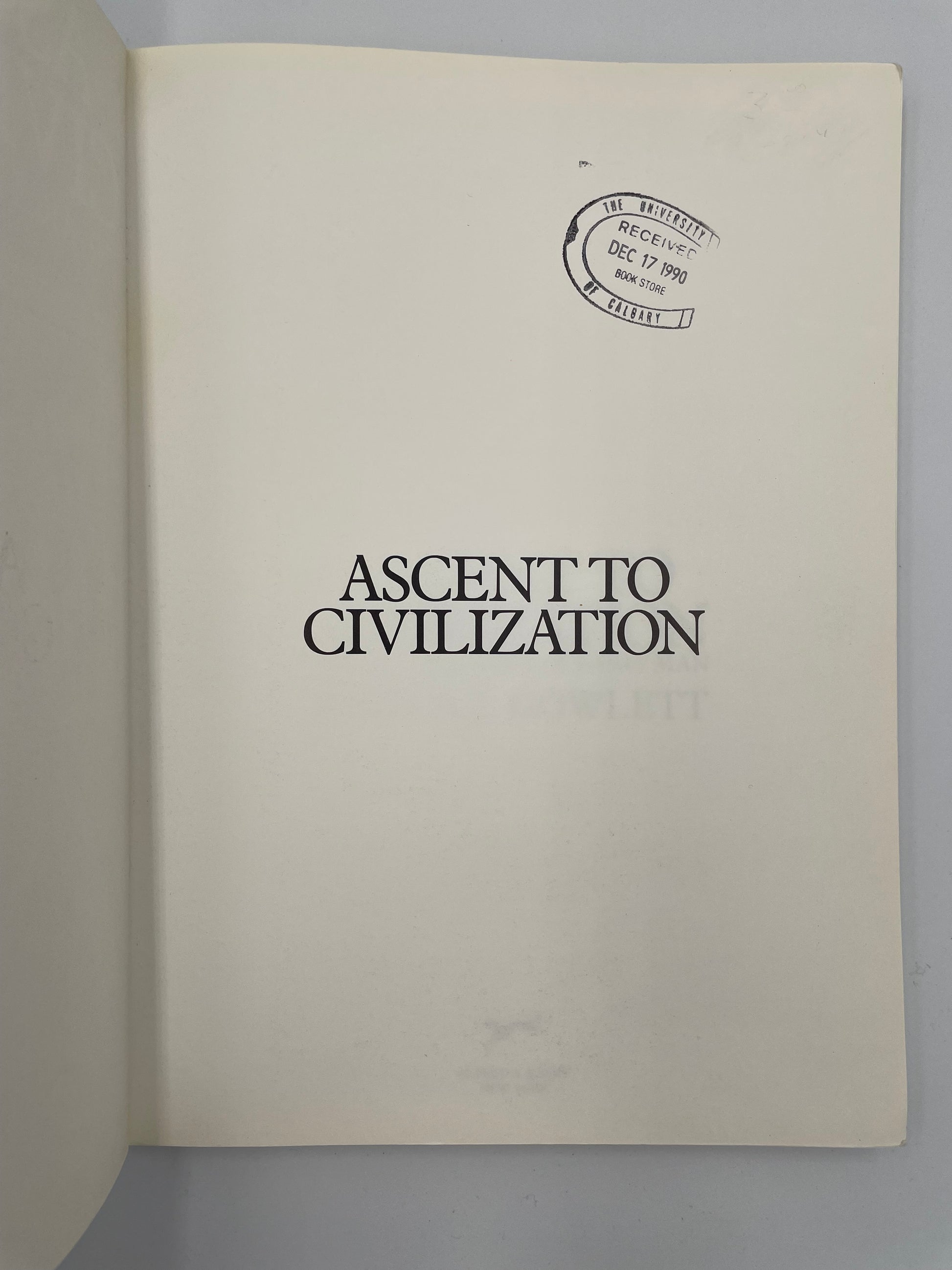 Title page of 'Ascent to Civilization' with a visible stamp on the cover against a gray background