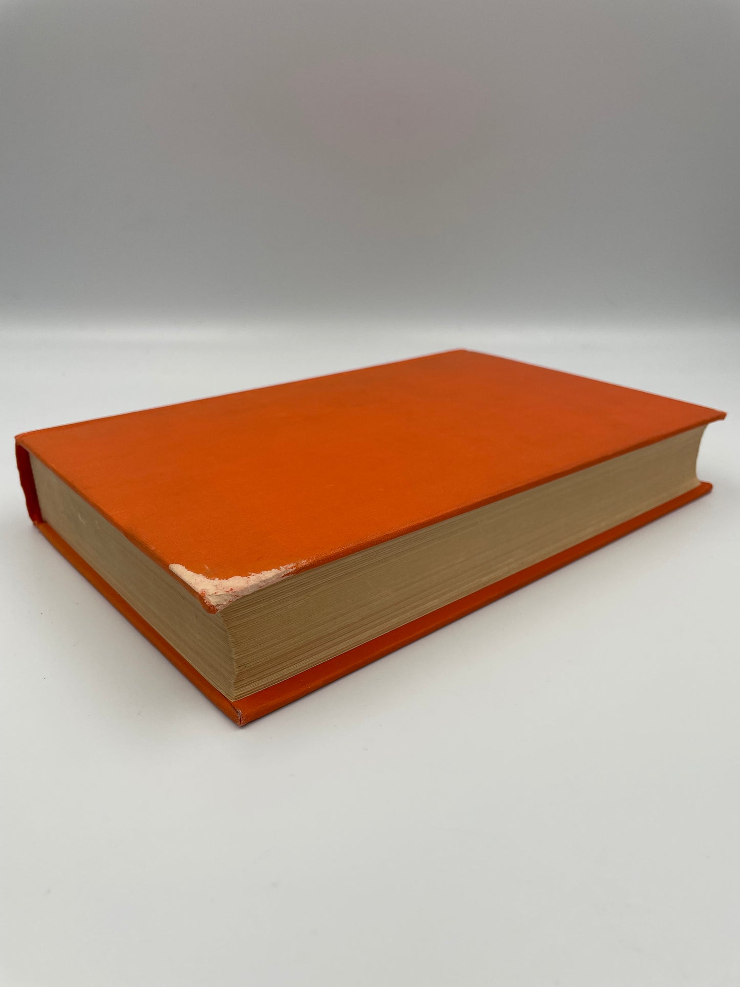 Orange book with faded corner.