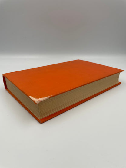 Orange book with faded corner.