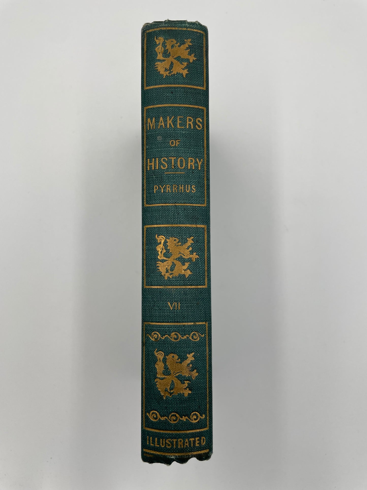 Book spine of  ‘Makers of History: Pyrrhus’ by Jacob Abbott with decorative gold text and designs on a white background