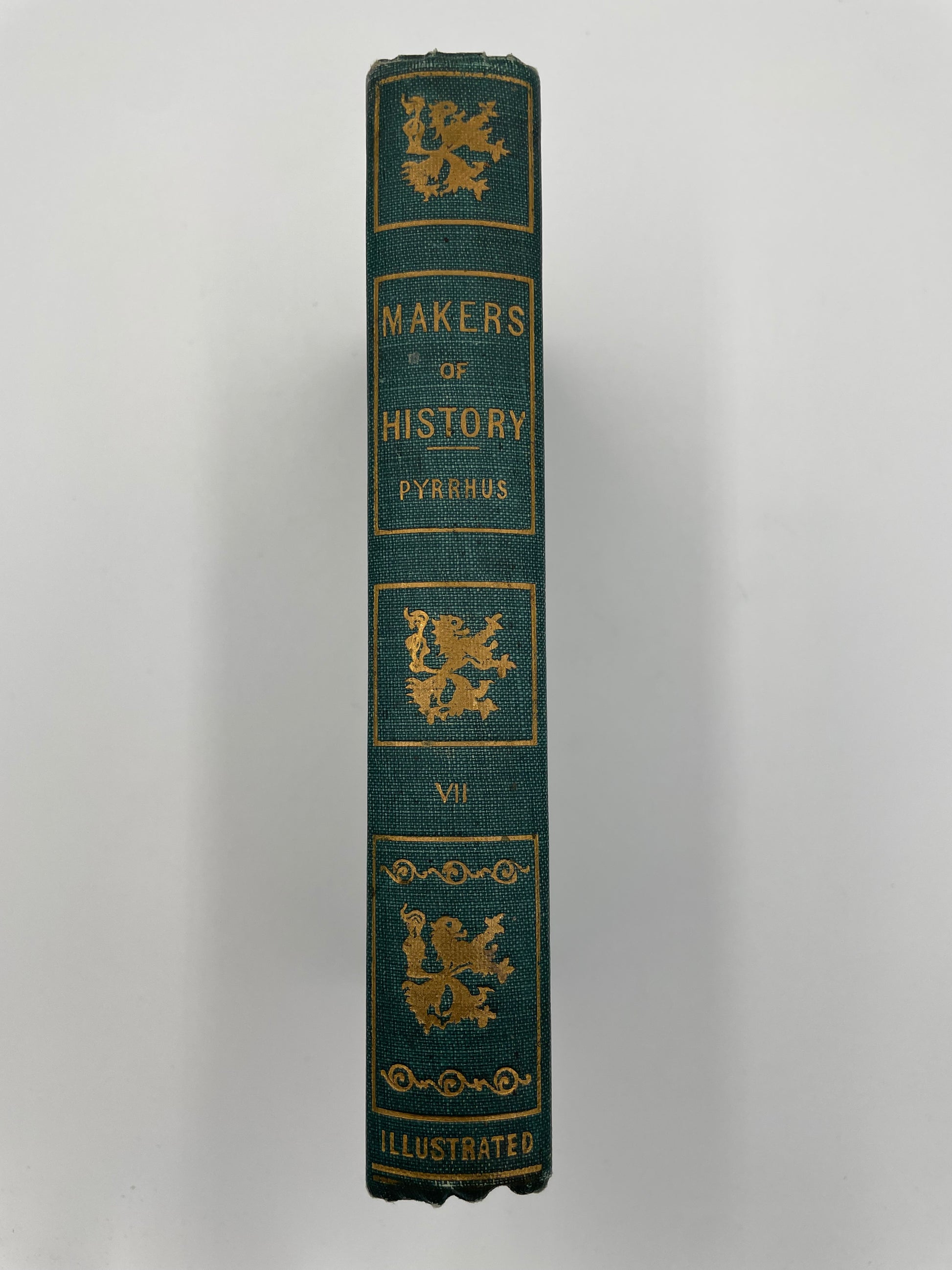Book spine of  ‘Makers of History: Pyrrhus’ by Jacob Abbott with decorative gold text and designs on a white background