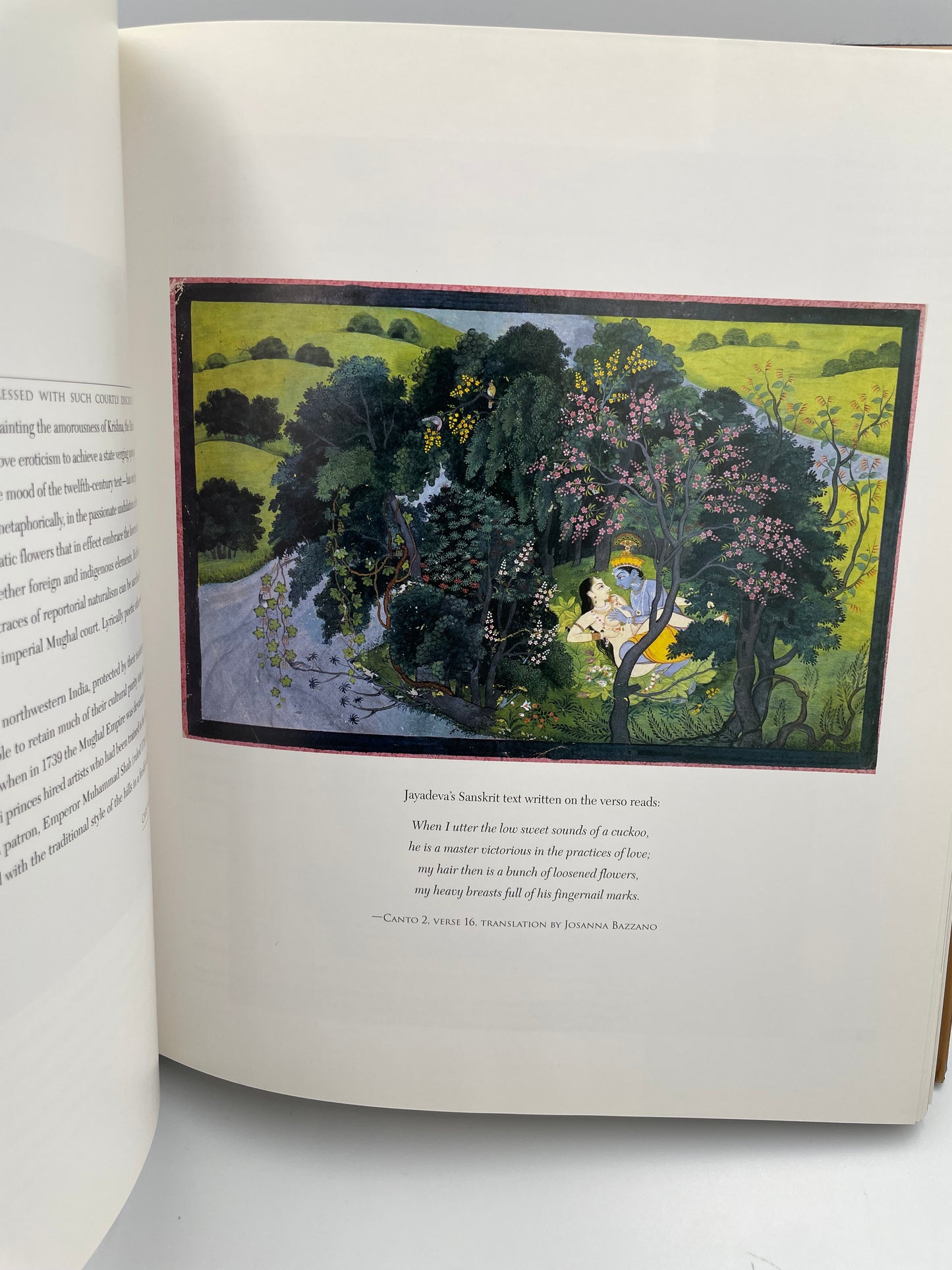 Open book with a colorful illustration of a forest scene on a white background