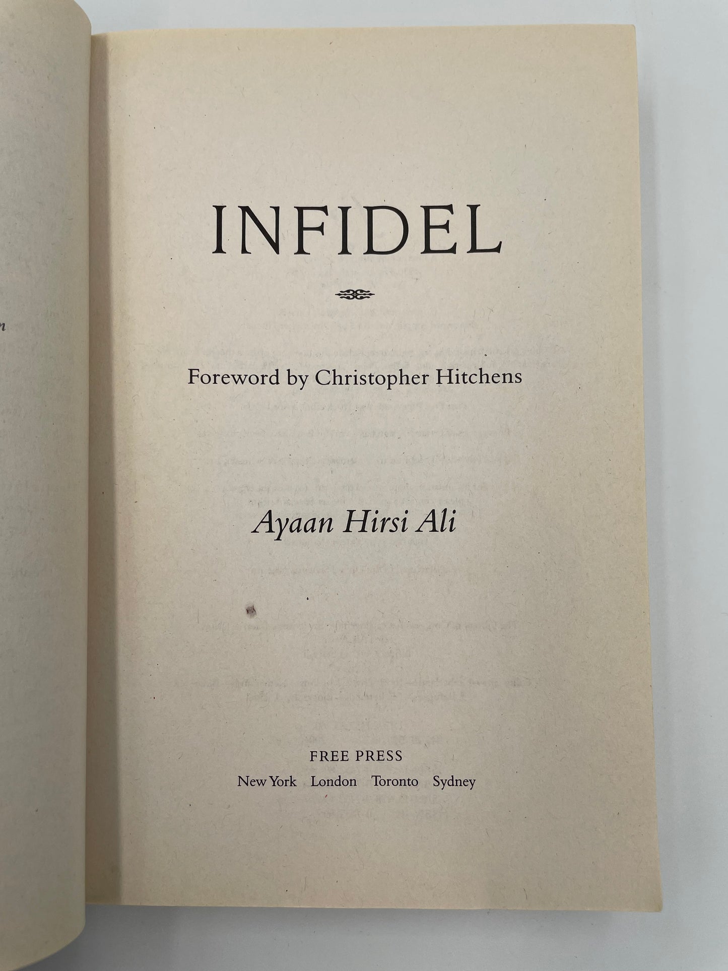 Title page  of 'Infidel' by Ayaan Hirsi Ali with a beige background