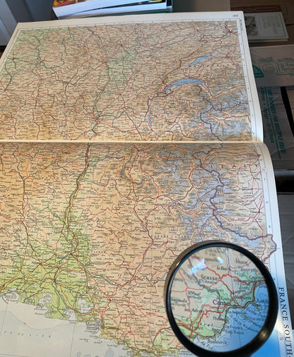 Map of France with a magnifying glass on top from Times Atlas of the world 1968 Edition