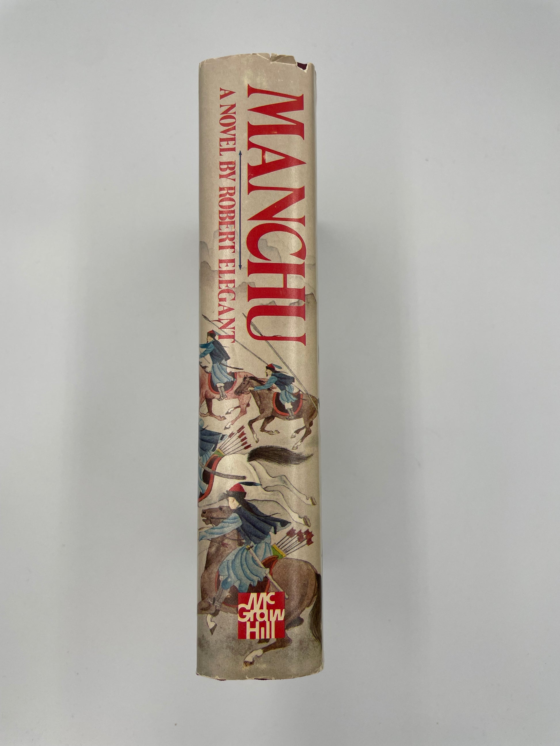 Book spine titled 'Manchu' by Robert Elegant on a light gray background