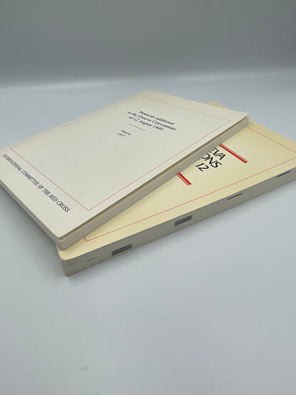 stacked copies of "The Geneva Conventions of August 12 1949" AND "Protocols additional to the Geneva Convention of 12 August 1949"