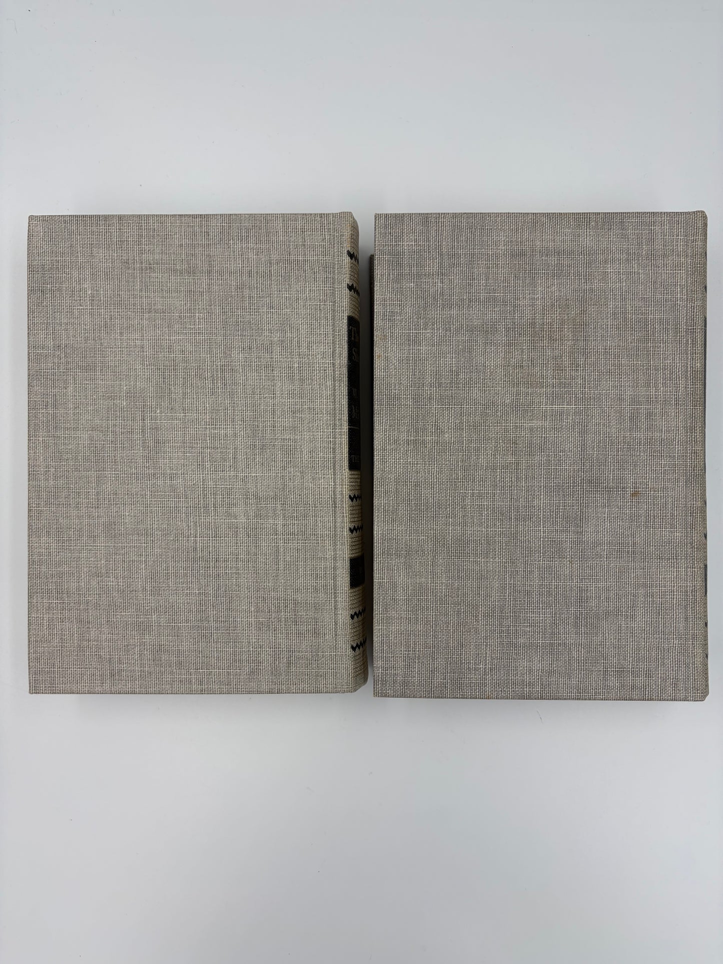 Two gray textured back book covers on a  white background.