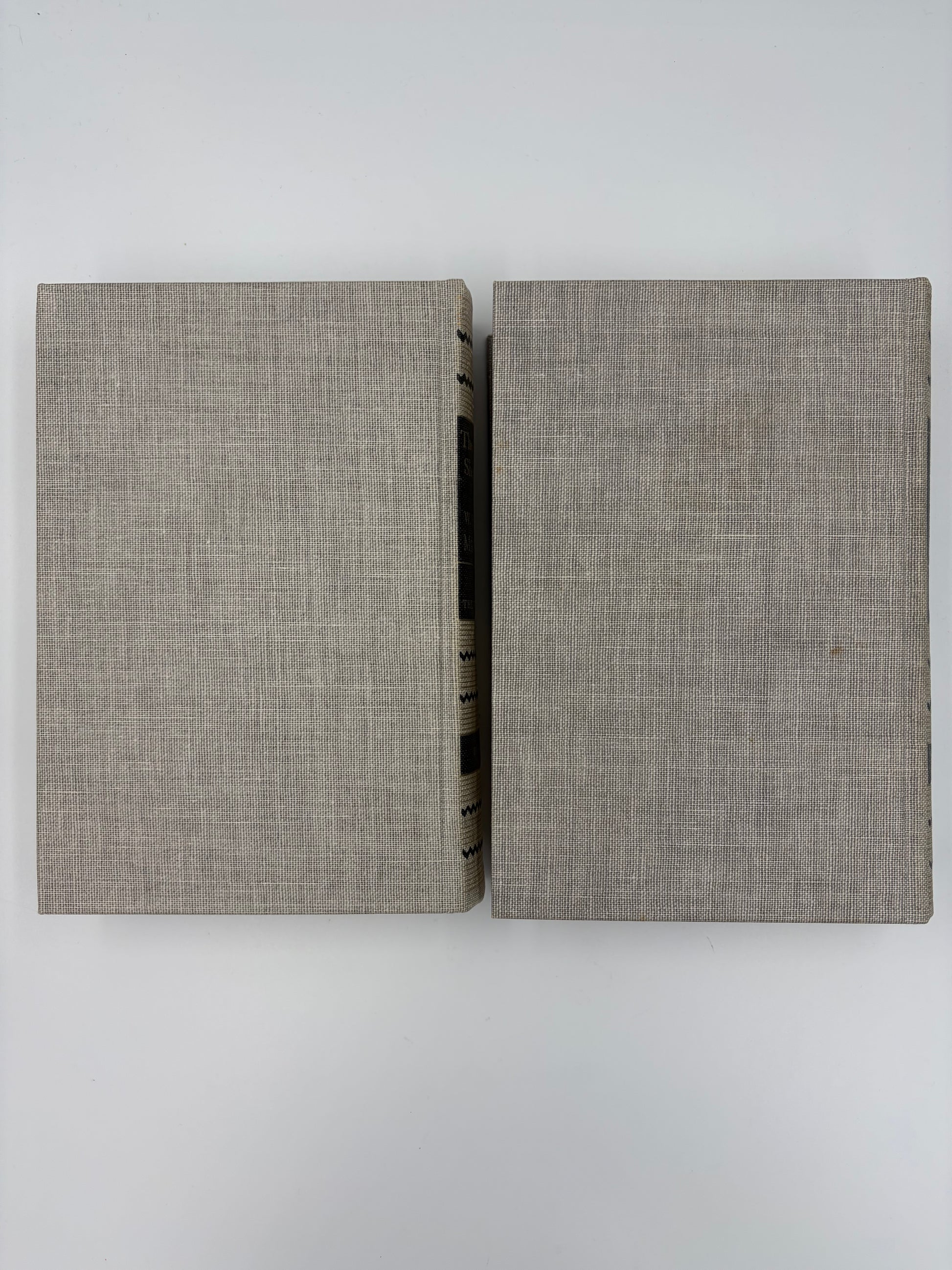 Two gray textured back book covers on a  white background.