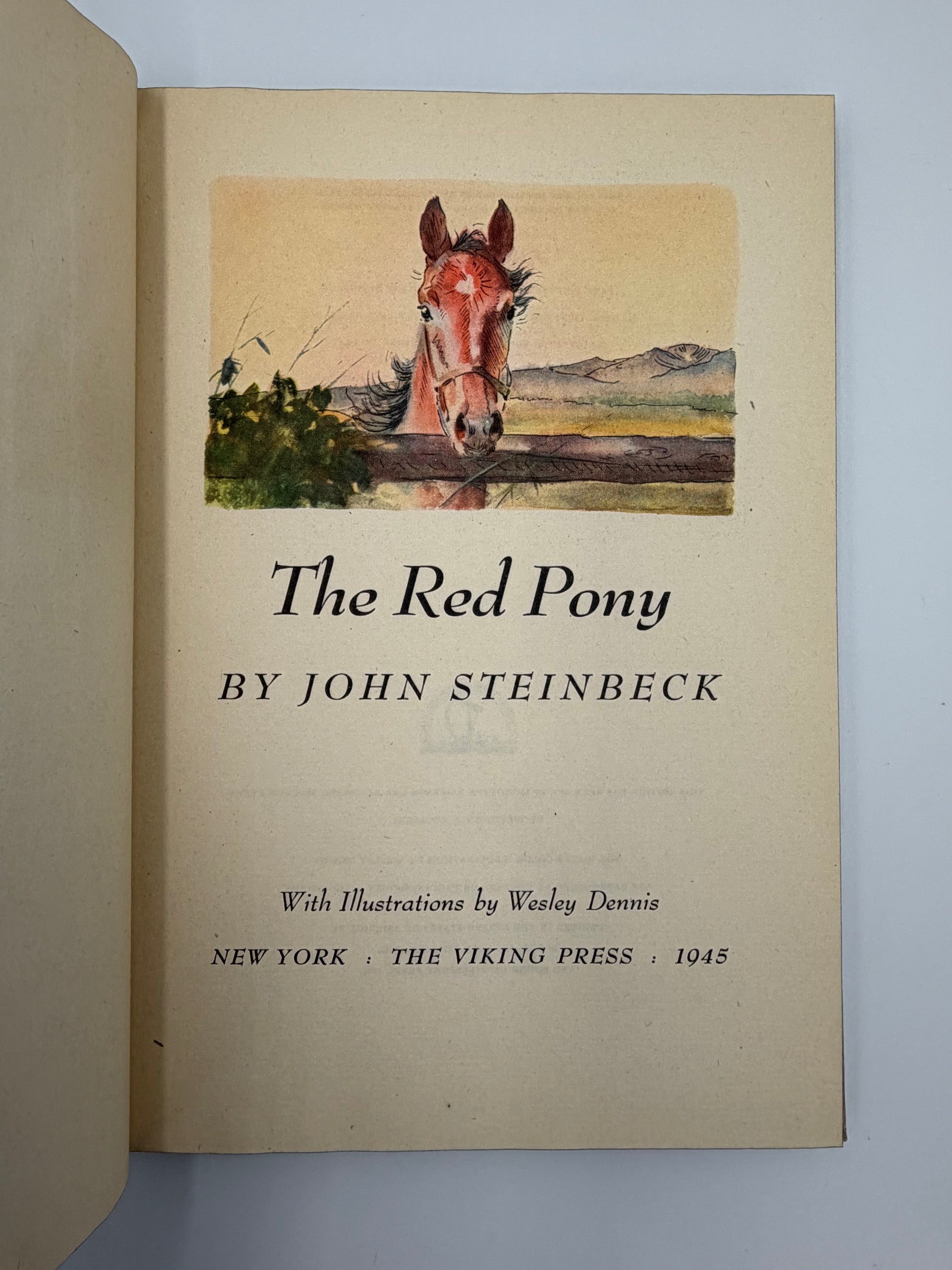 Title page of 'The Red Pony' by John Steinbeck with a horse illustration on a plain background. 1945 edition. 