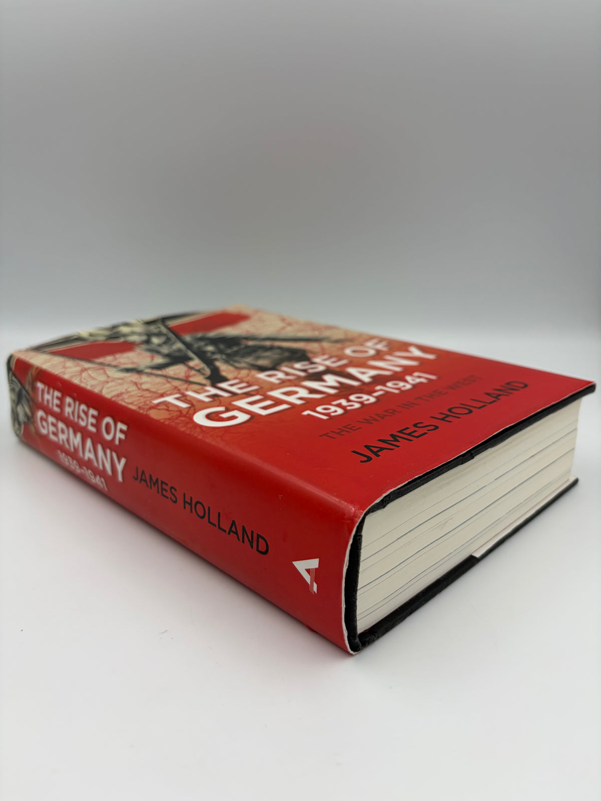 Side view of book 'The Rise of Germany 1939-1941' by James Holland, featuring a red dust jacket with white and black text and a historical illustration.