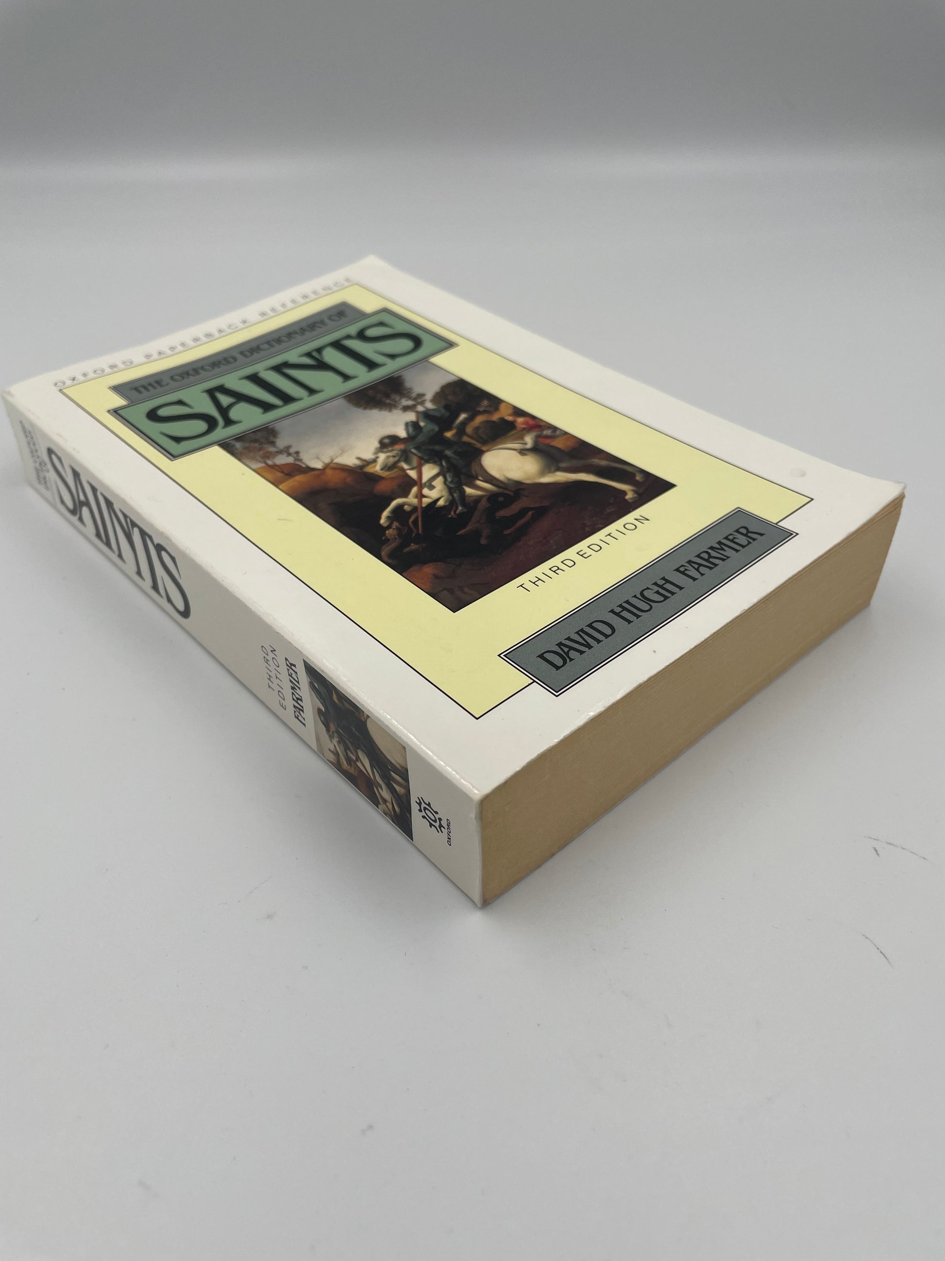 Book cover and spine view of ‘ The Oxford Dictionary of Saints’ by David Hugh Farmer