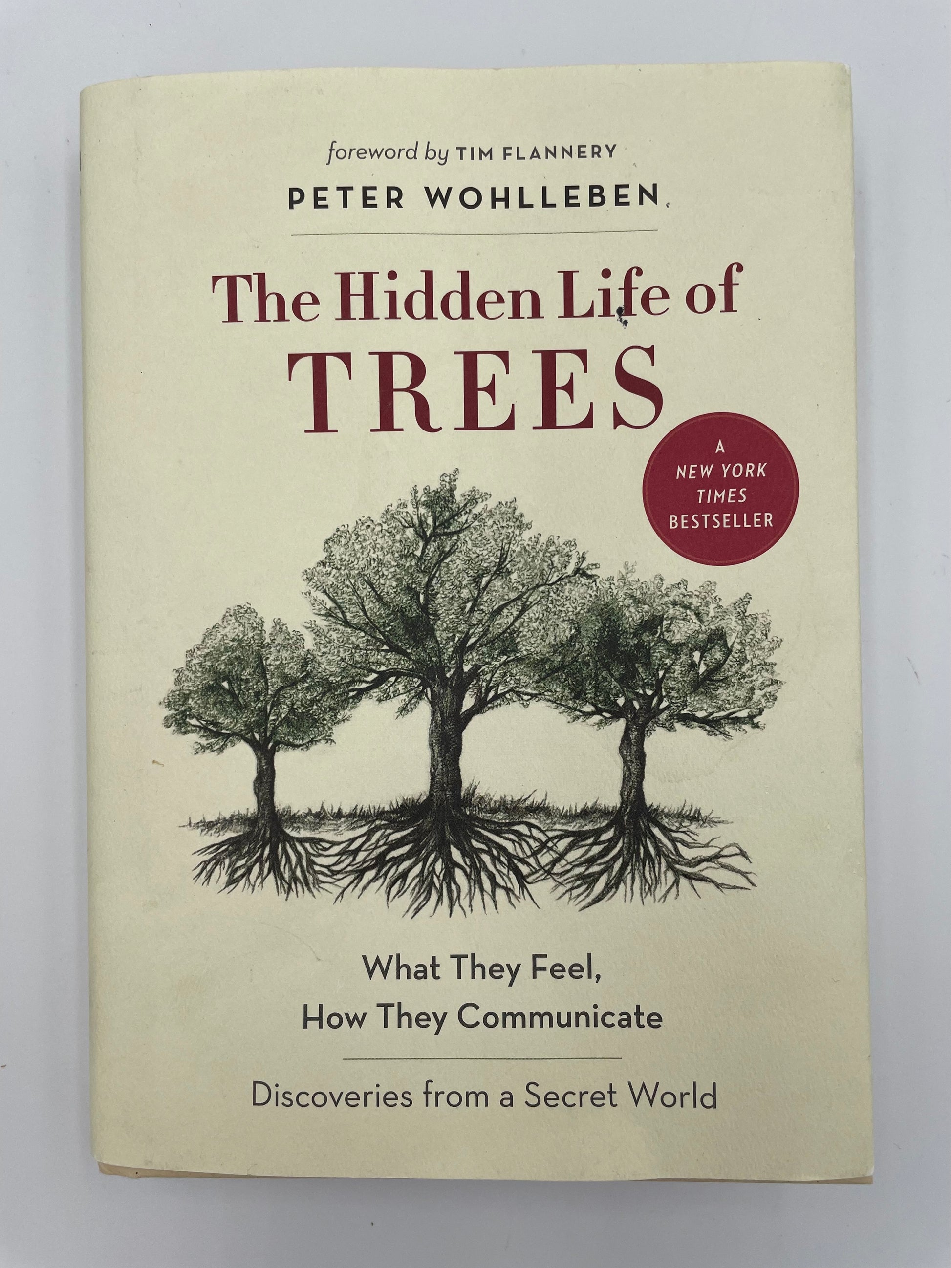 Book cover of 'The Hidden Life of Trees' by Peter Wohlleben with a beige background.
