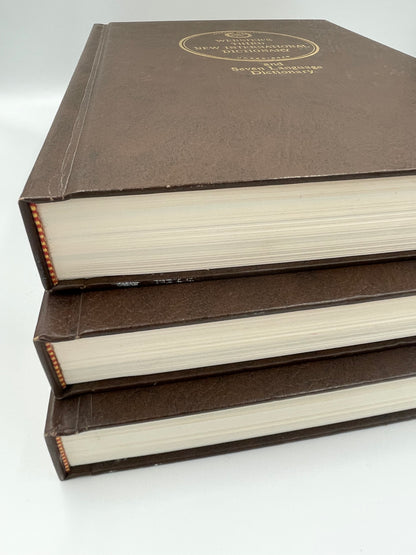 3 volumes stacked with binding details of Webster’s Third New International Dictionary. 