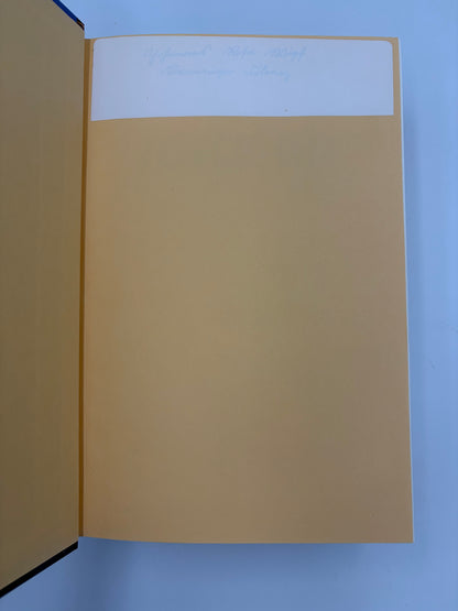 Open book with a plain beige page on a blue background.