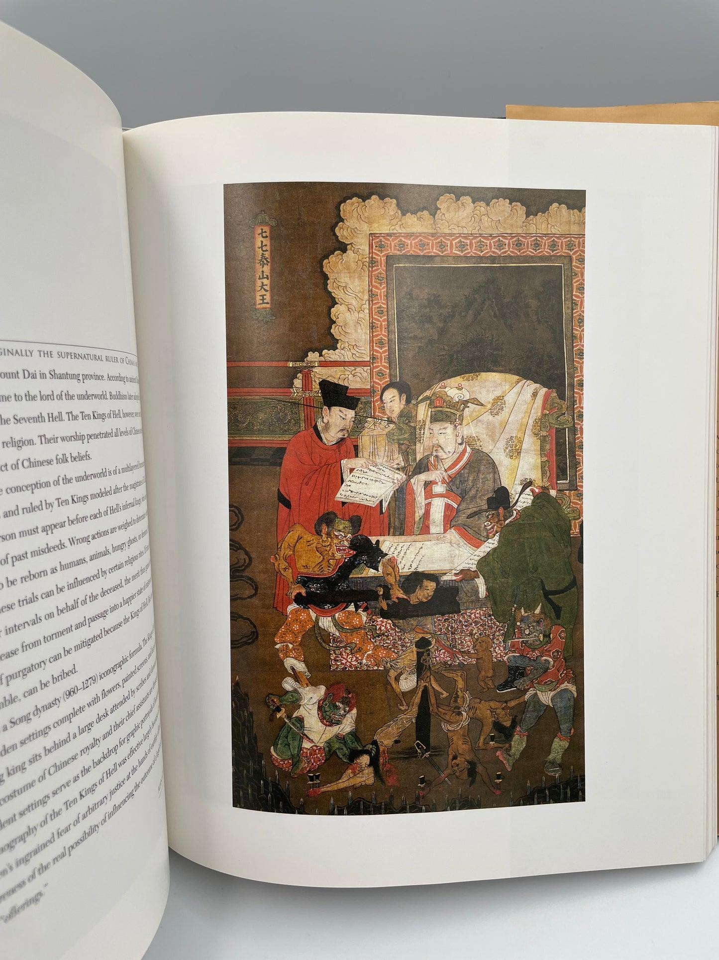 Open book with a detailed illustration on a gray background
