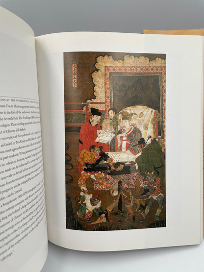 Open book with a detailed illustration on a gray background