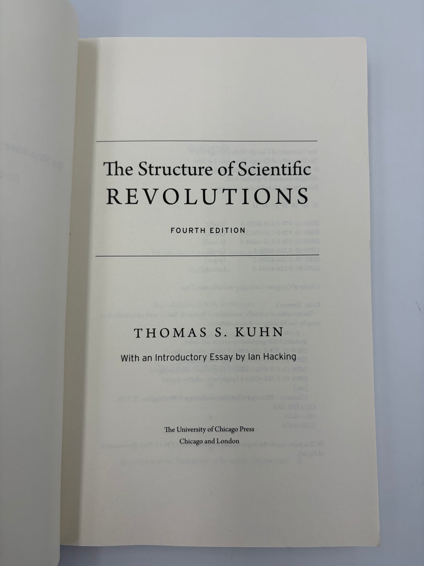Titlel page from, 'The Structure of Scientific Revolutions' by Thomas S. Kuhn on a light gray background.