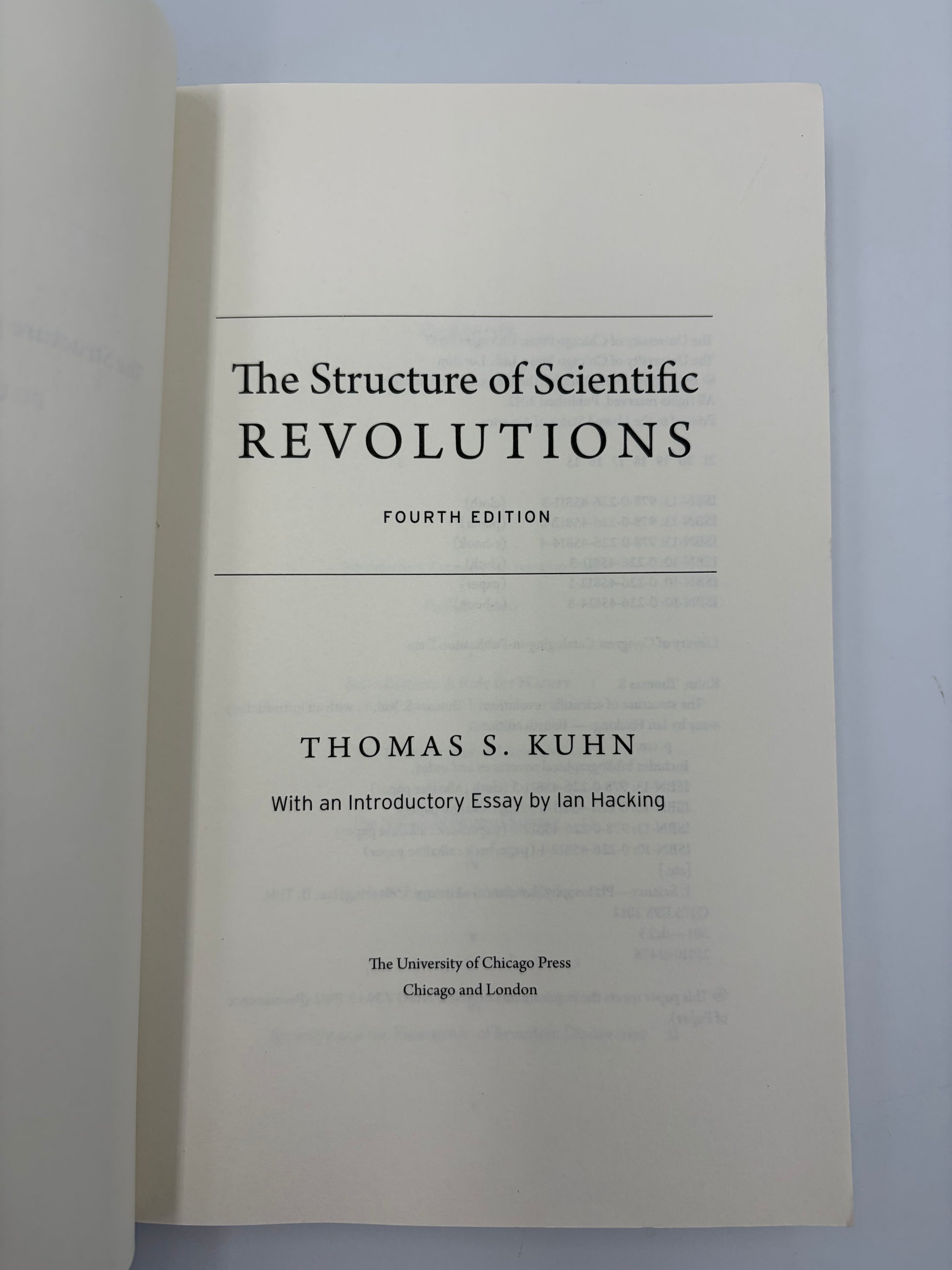 Titlel page from, 'The Structure of Scientific Revolutions' by Thomas S. Kuhn on a light gray background.