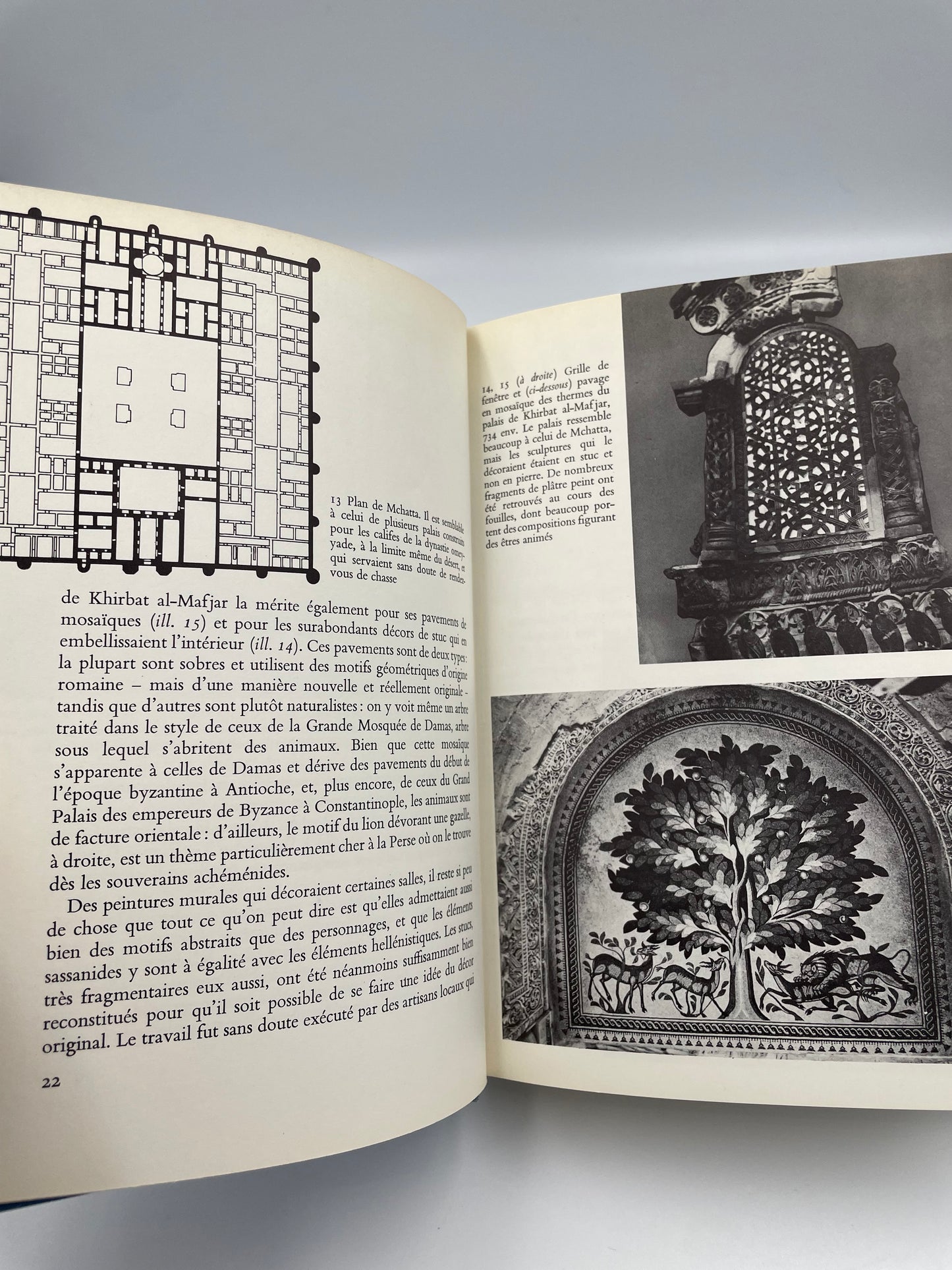 Open book with printed text and black and white illustrations on a gray background  from ‘l’Art de l’Islam’.