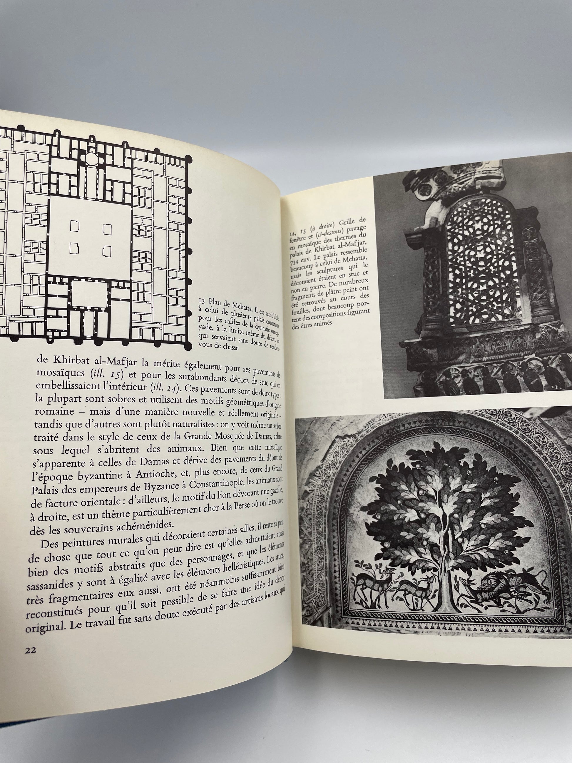 Open book with printed text and black and white illustrations on a gray background  from ‘l’Art de l’Islam’.