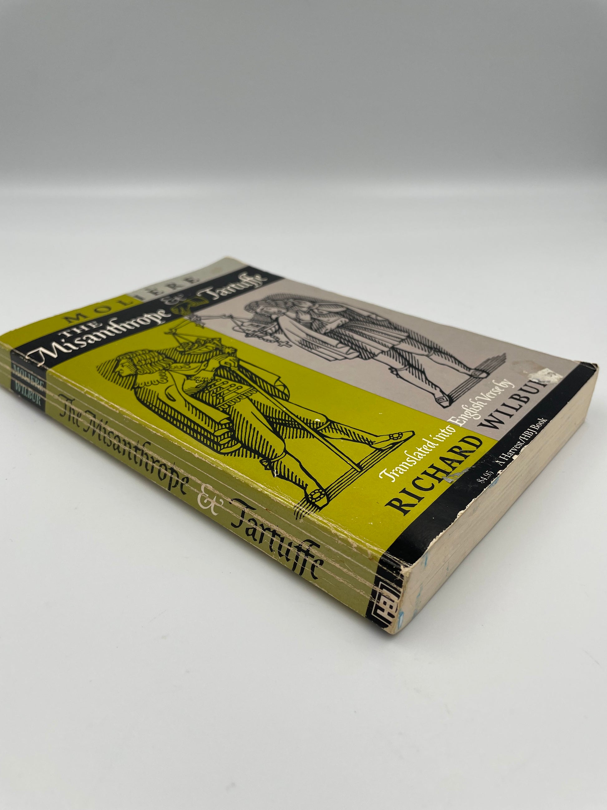 Vintage book of ‘Molière: The Misanthrope and Tartuffe’ with yellow and black cover on a white background