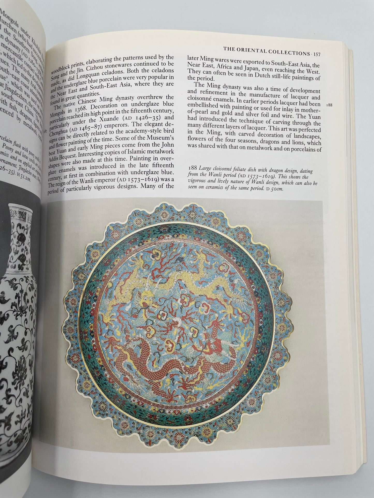 Open book with a decorative plate illustration and text on a white background