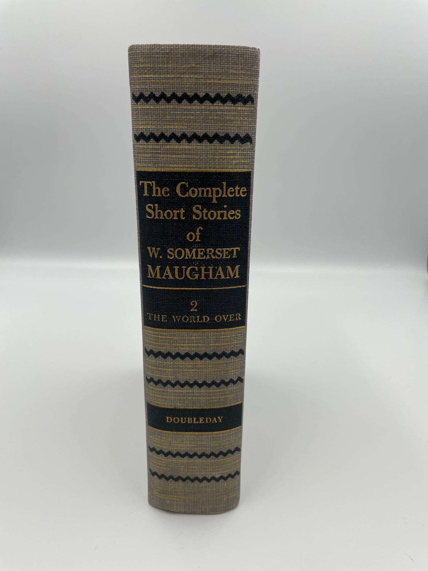 Book titled 'The Complete Short Stories of W. Somerset Maugham' on a white background