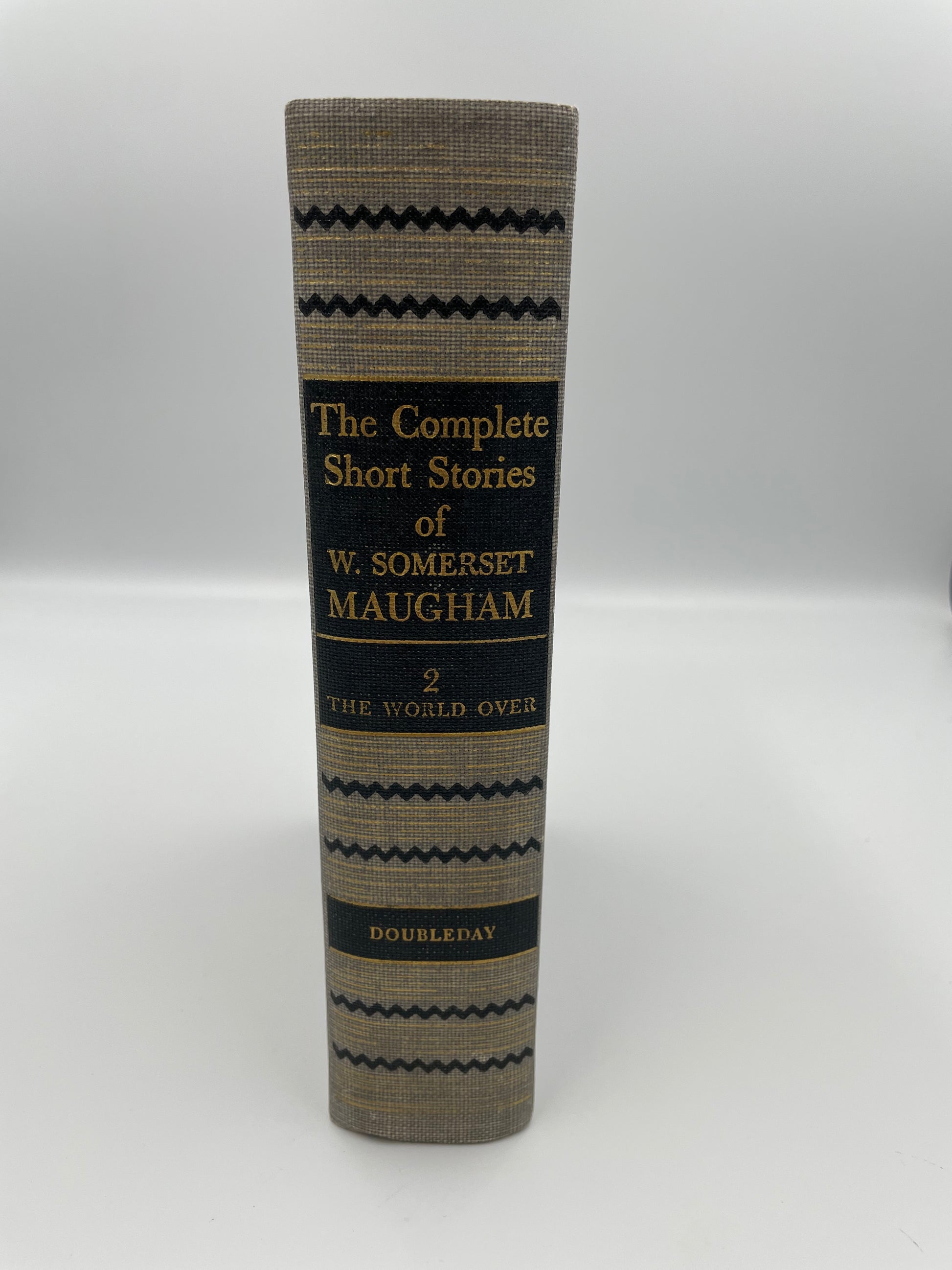 Book titled 'The Complete Short Stories of W. Somerset Maugham' on a white background